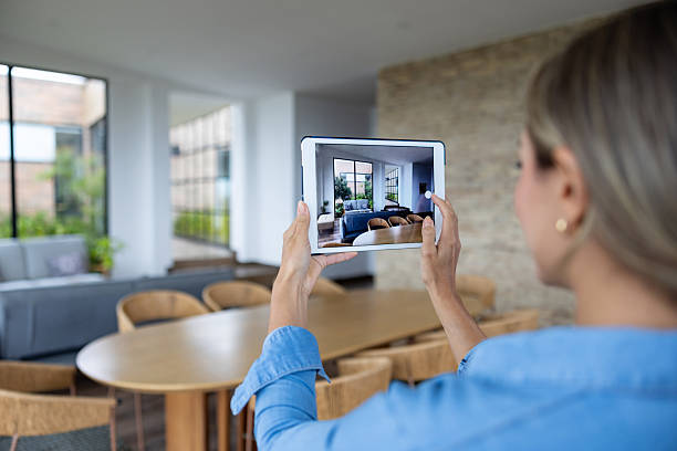 Person photographing a room with a tablet